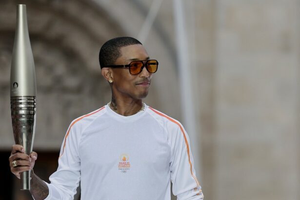 Pharrell Williams carries the torch at the 2024 Paris Olympics