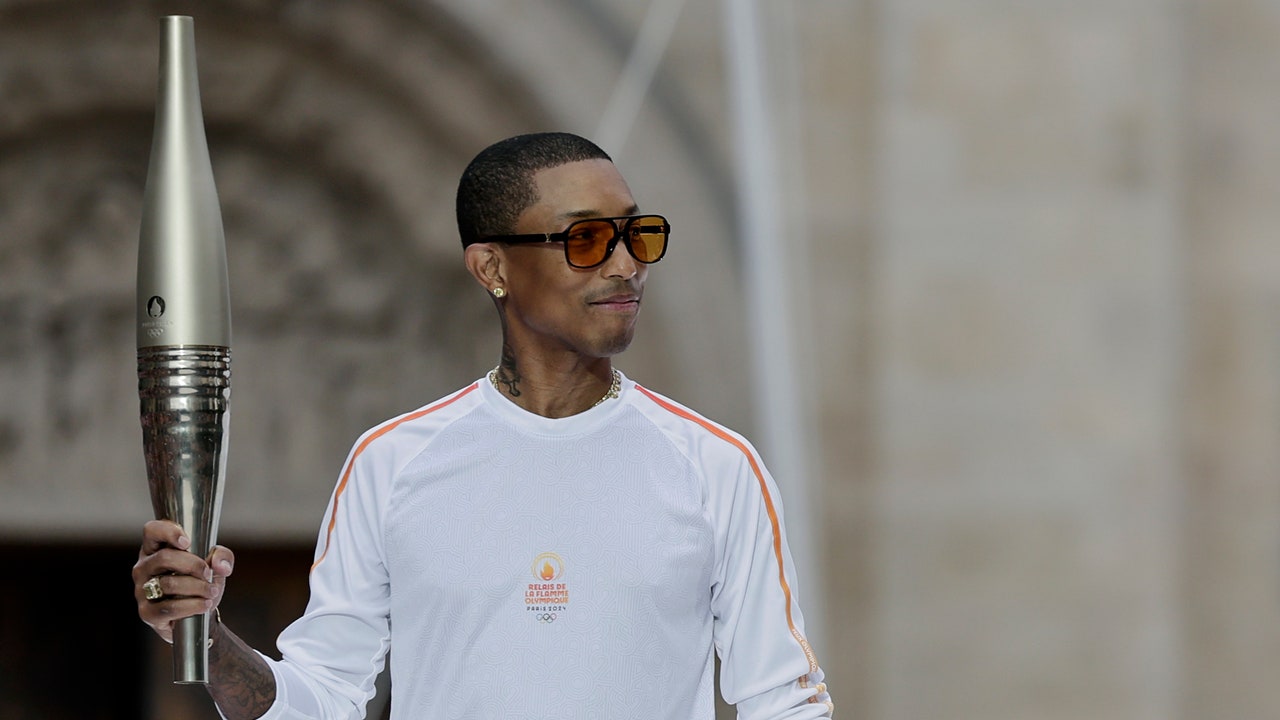 Pharrell Williams carries the torch at the 2024 Paris Olympics