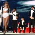 Taylor Swift and Travis Kelce hug as they leave the Eras Tour in Germany