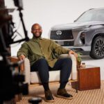 Tim Hinshaw sitting in a chair in front of an 2025 INFINITI QX80